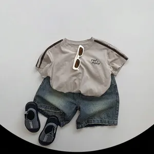Kids casual summer outfit with beige t-shirt and washed denim shorts for boys and girls