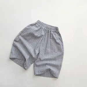 Detail of children's light blue striped cotton shorts with elastic waist and side pockets