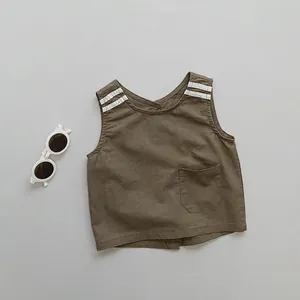 Detail of linen cotton kids vest in olive brown with white shoulder stripes and pocket