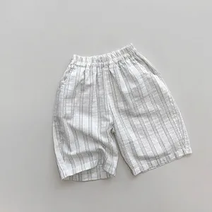 Detail of children striped cropped pants featuring elastic waist and cotton fabric