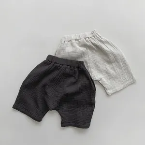 Detail of soft double-layer cotton gauze texture on charcoal and cream kids shorts