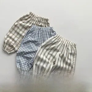 Close-up of three kids checkered mosquito pants with elastic waist and ankle cuffs