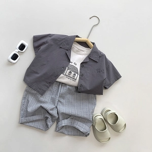 Kids three-piece summer cotton outfit with grey short-sleeve shirt, T-shirt, and striped shorts
