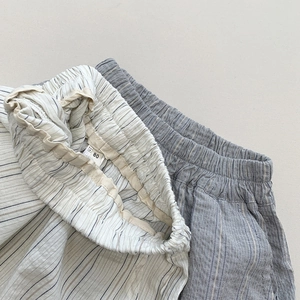Detailed view of elastic waist and vertical stripes on cotton-linen kid's trousers