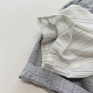 Close-up of lightweight grey vertical striped cotton fabric with natural texture details