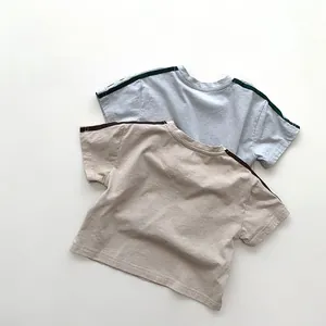 Detailed flat lay of beige and grey blue cotton knit t-shirts with striped sleeves
