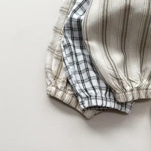 Detail of children's cotton linen joggers featuring elastic cuffs and plaid patterns