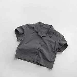 Close-up of lightweight dark grey cotton shirt with Café No.27 print on chest