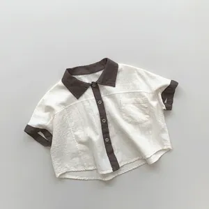 Close-up of color-block kids shirt featuring breathable cotton linen and contrast trim