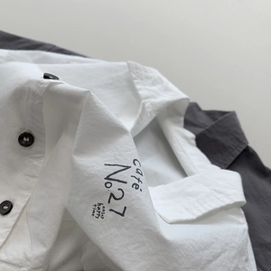 Kids lightweight white cotton shirt with black cafe typography and contrasting buttons