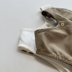 Detail view of linen-cotton kids vest showing natural fabric texture and vintage buttons
