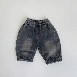 Detailed macro view of vintage washed grey kids denim shorts with elastic waistband