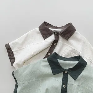 Detailed close-up of textured cotton linen kids short sleeve shirts with color-block collars