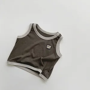 Détail du gilet en tricot olive pour enfants avec col côtelé et écusson JUST NOW