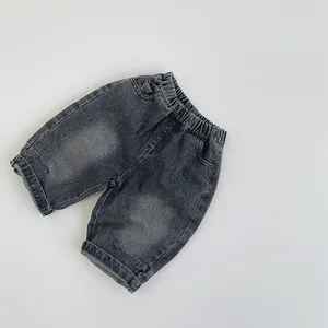 Detail of children's washed gray denim shorts with elastic waistband and folded hem