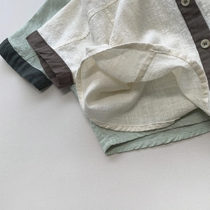Close-up of color-block cotton linen kids shirt showing buttons and breathable fabric texture