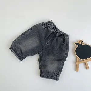 Flat lay of retro dark grey kids washed denim shorts with elastic waist and cuffed hems