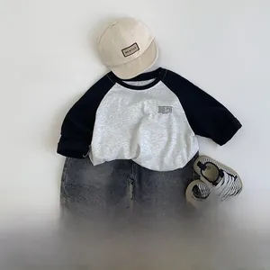 Flat lay of vintage style kids denim shorts with cotton raglan tee and accessories