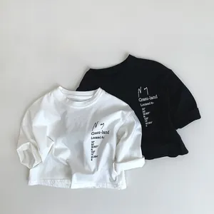 Detailed view of kids cotton t-shirts featuring letter prints and soft ribbed crewneck