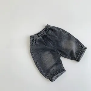 Detailed macro view of dark grey washed denim kids shorts with elastic waistband and pockets