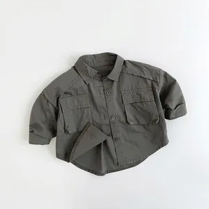 Flat lay of olive green cargo shirt for kids featuring large pockets and button-down collar