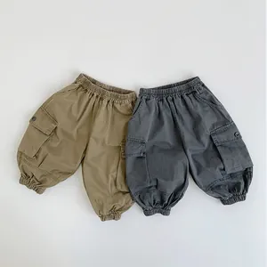 Close-up of khaki and dark grey cargo pants with elastic waist and large side pockets