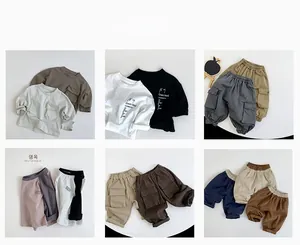 Flat lay of vintage plaid shirts and cargo pants in earthy tones for kids