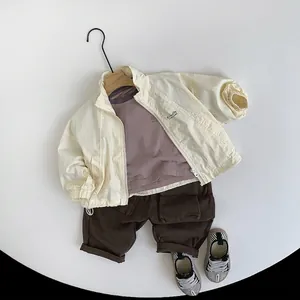 Kids three-piece set featuring a beige zip jacket, purple tee and brown cargo pants