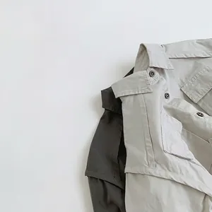 Kids cotton utility shirts in grey, featuring cargo pockets and minimalist design