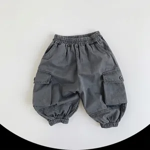 Close-up of deep grey cargo pants showing elastic waistband and large side pockets
