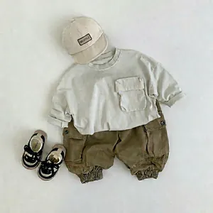 Minimalist boys cargo pants set with cream long sleeve tee and khaki joggers in Korean style