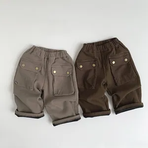 Detail of fleece-lined cargo pants featuring elastic waist and large flap pockets