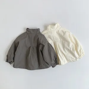Detailed flat lay of toddler stand-collar jackets in charcoal grey and cream white colors