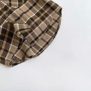 Close-up of vintage brown plaid flannel shirt with round hem and button details