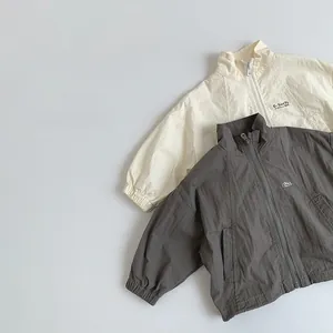 Detail of kids lightweight windbreaker jackets with stand collar and G-Sun 7 letter print