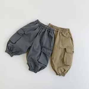 Detail view of elastic waistband and large cargo pockets on children's twill pants