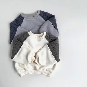Detail of children's fleece sweatshirt with raglan sleeves and diamond quilted stitching