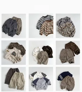 Flat lay of diverse Korean style children clothing pieces in neutral earth tones