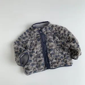 Close-up of thick grey-blue fleece kids jacket with navy trim and snap buttons