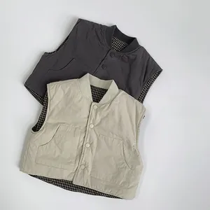 Detail of reversible quilted vest for kids with snap buttons and check lining