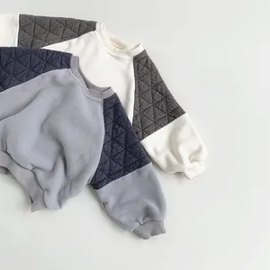 Detail of kids fleece sweatshirts with quilted raglan sleeves and ribbed crew neck collars