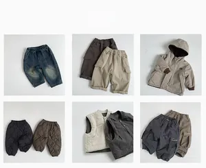 Flat lay collection of vintage-style kids' fleece-lined trousers and warm outerwear vests