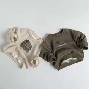 Detail showing plush fleece lining and colorful burger bear prints on kids sweatshirts