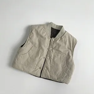 Detailed view of quilted cotton vest for children with plaid lining and snap buttons