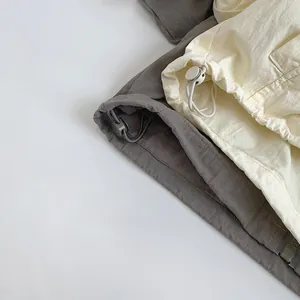 Detail of adjustable drawstring hem with toggle on casual windbreaker jackets