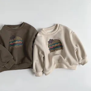 Close-up of ribbed crewneck and cuffs on fleece-lined kids sweatshirts with burger print