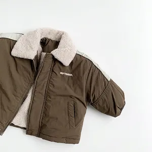 Detail of warm winter kids jacket featuring sherpa collar and September embroidery