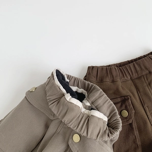 Detail of kids cargo pants showing elastic waistband and thick fleece lining for winter
