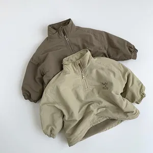 Detail of half-zip kids' windproof fleece shirts in dark coffee and light beige tones