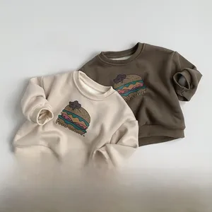 Close-up of kids fleece-lined sweatshirts featuring hamburger prints and ribbed cuffs
